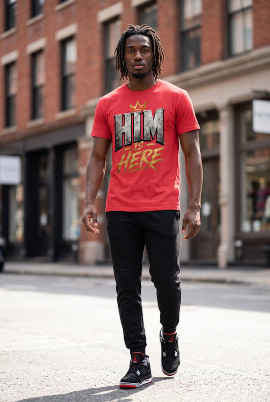 Man wearing a red t-shirt with graphic design walking on a city street.