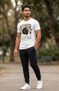 Man wearing a white t-shirt with a graphic design outdoors