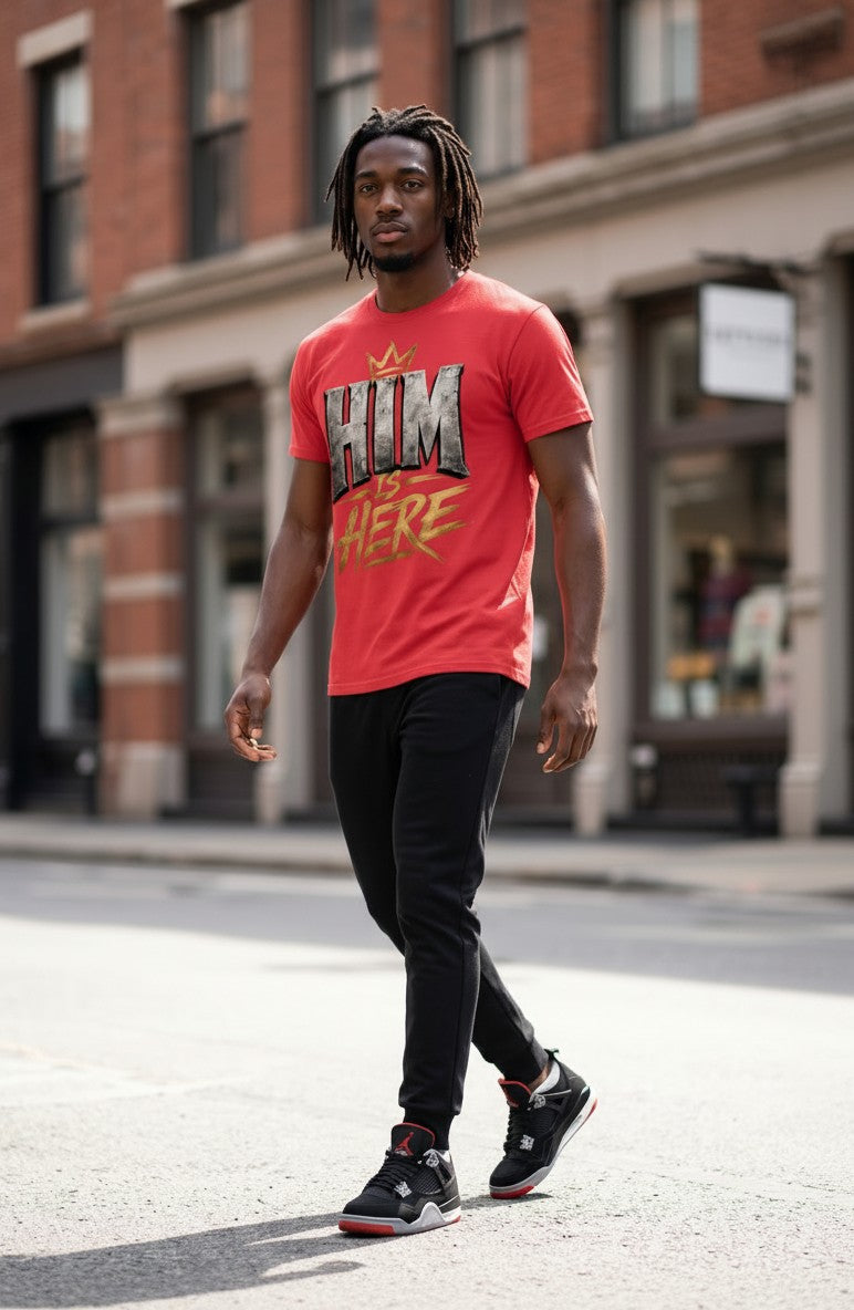 Man wearing a red t-shirt with graphic design walking on a city street.