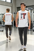 Two individuals wearing 'Iron Therapy' branded sleeveless shirts in a gym setting.