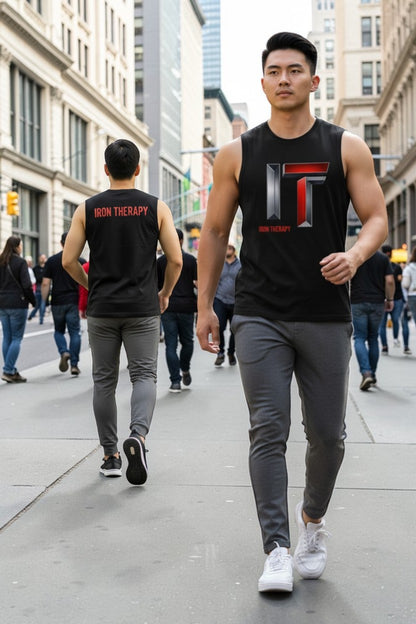 Two men walking on a city street wearing black tank tops with a logo.