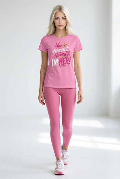 Woman wearing a pink outfit with a graphic t-shirt and leggings on a white background