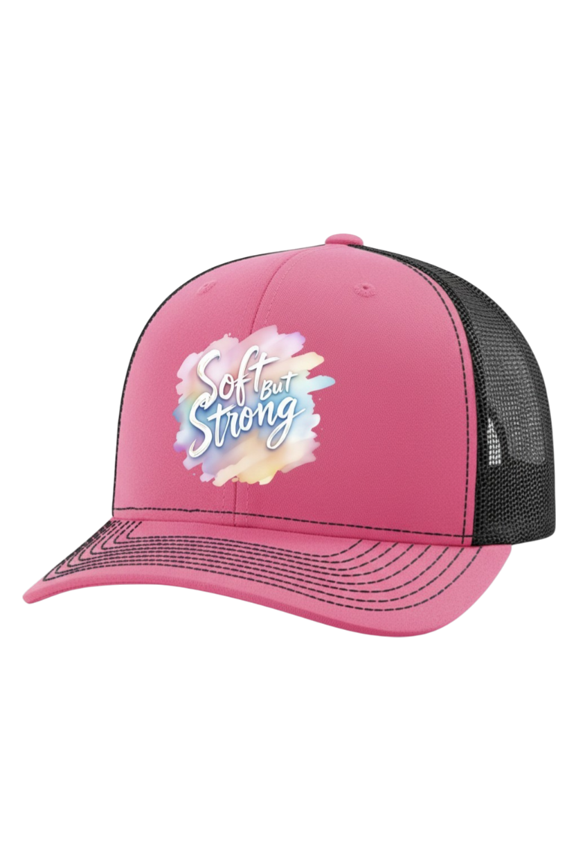 Pink trucker hat with 'Soft but Strong' design on a white background