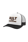 White and black cap with 'BUILT FOR PRESSURE' text on a white background