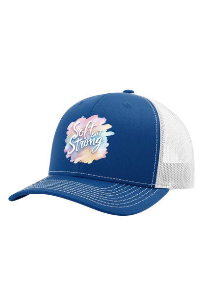 Blue and white cap with 'Soft but Strong' text on a white background