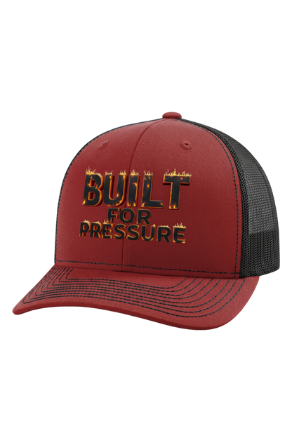 Red and black cap with 'Built for Pressure' text on a white background