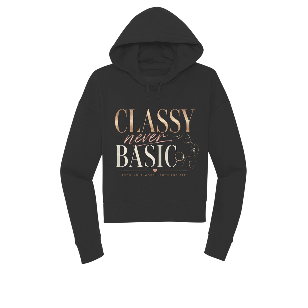 A black cropped hoodie with a graphic print on the front reading 'CLASSY never BASIC' in rose gold and white lettering, accompanied by a line art illustration of a woman's profile. The hoodie is displayed on a clean white background.