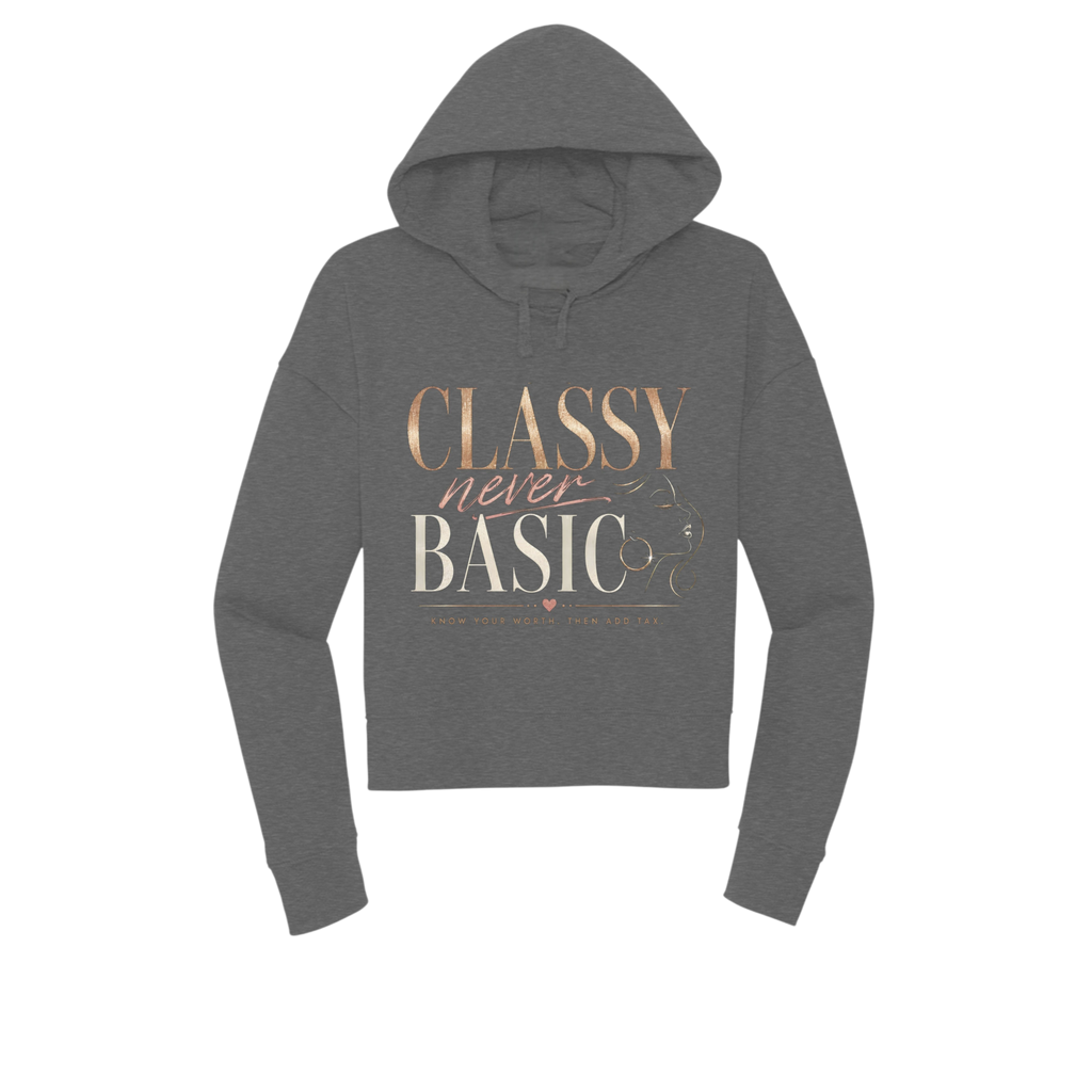 A dark gray cropped hoodie with a graphic text print reading 'CLASSY never BASIC' in rose gold and cream lettering, displayed on a solid white background.