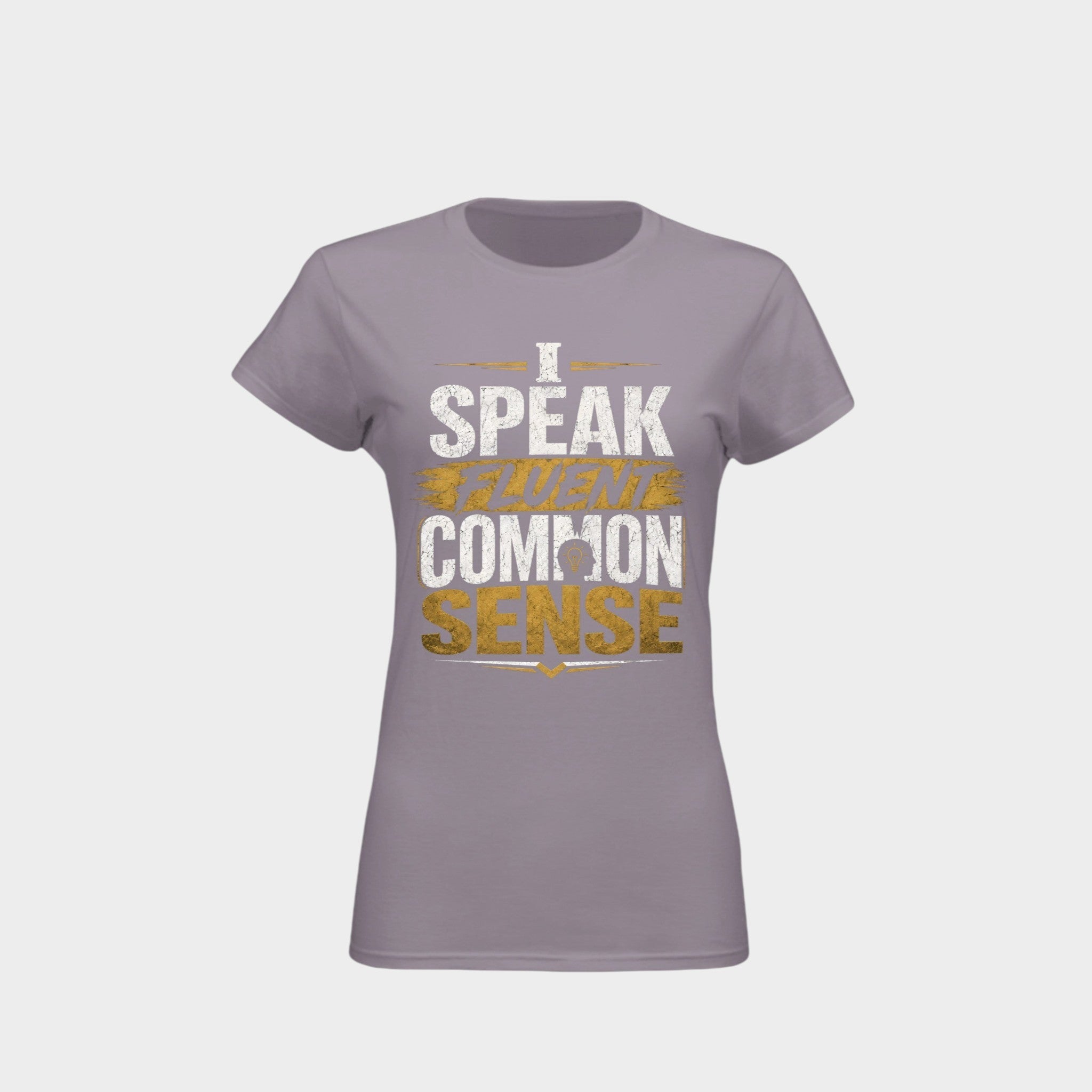 A women's short-sleeve crewneck t-shirt in a muted lavender-gray color, featuring a distressed graphic print on the front that reads 'I SPEAK TRUTH IN COMMON SENSE' in white and gold lettering, set against a light gray background.