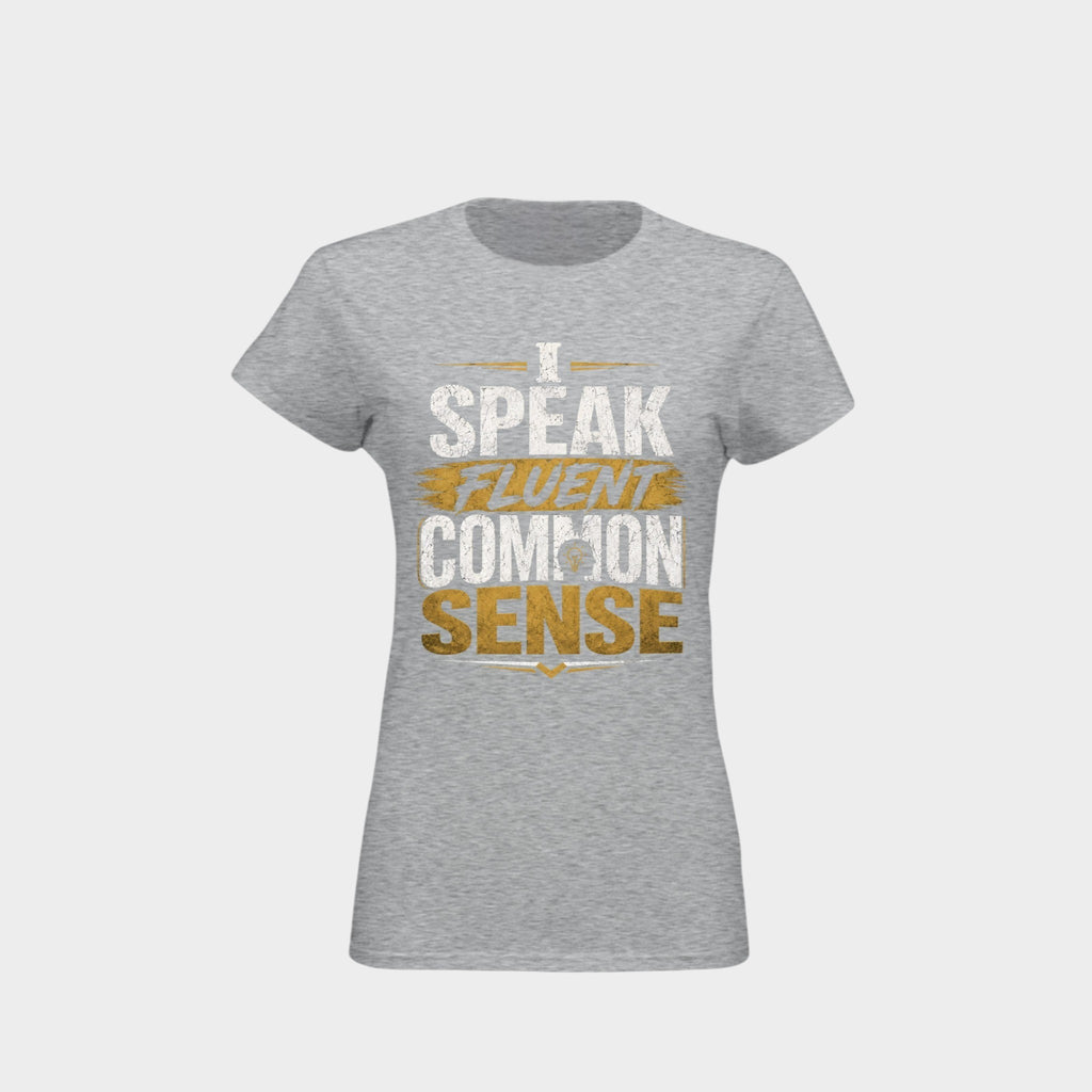 A women's heather gray short-sleeve t-shirt with a graphic print on the front reading 'I SPEAK FLUENT COMMON SENSE' in white and gold lettering, shown against a light gray background.