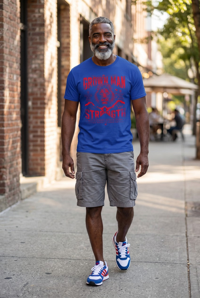 Man wearing a blue t-shirt with a graphic design, gray shorts, and blue sneakers walking on a sidewalk.