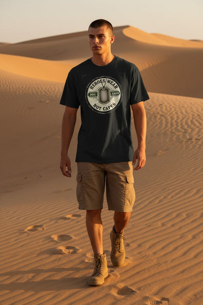Man wearing a black t-shirt with a logo and beige shorts walking in desert sand dunes.
