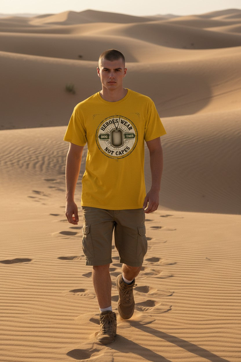 Man walking in the desert wearing a yellow t-shirt with a logo.