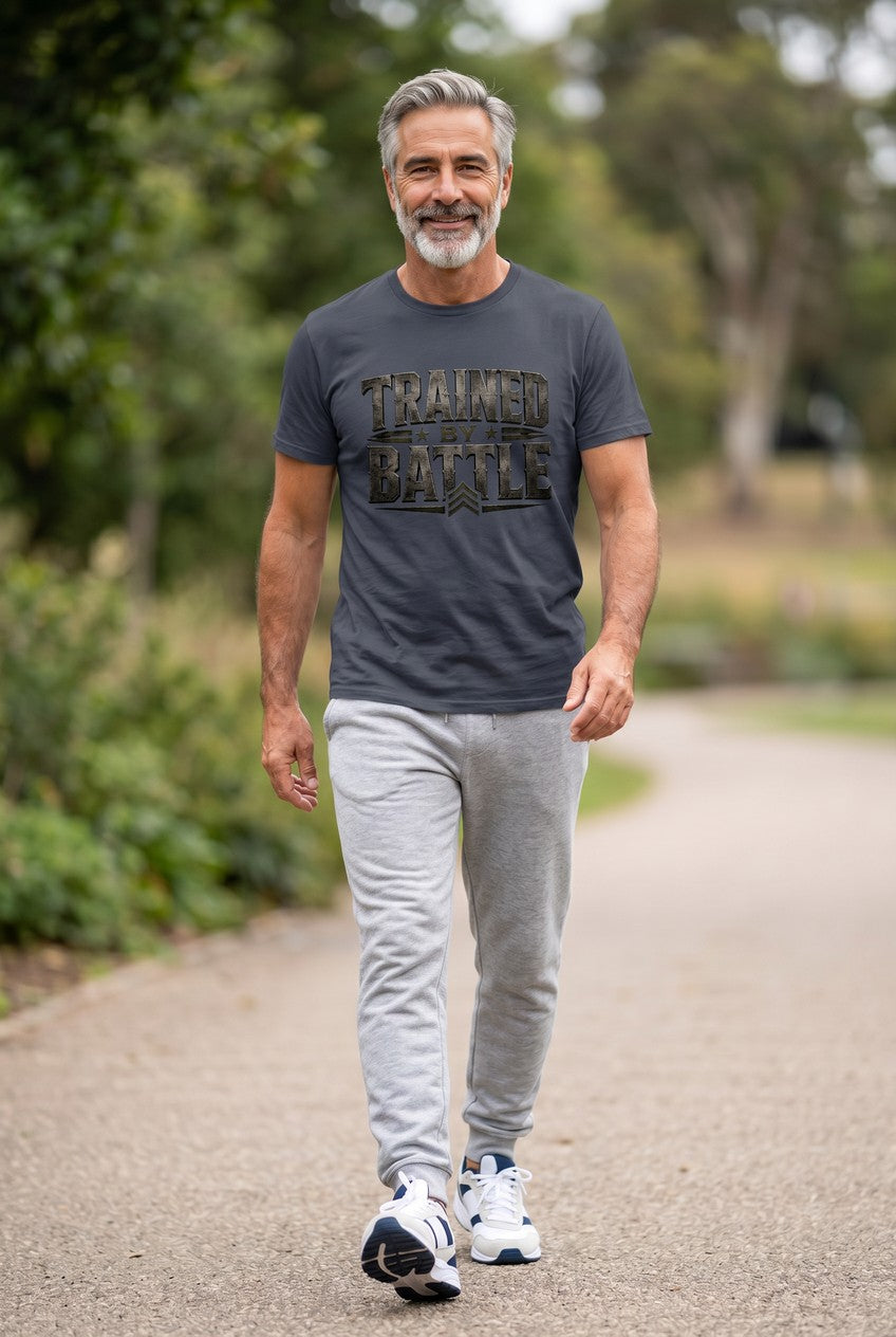 Man walking outdoors wearing a t-shirt with 'Trained Battle' text