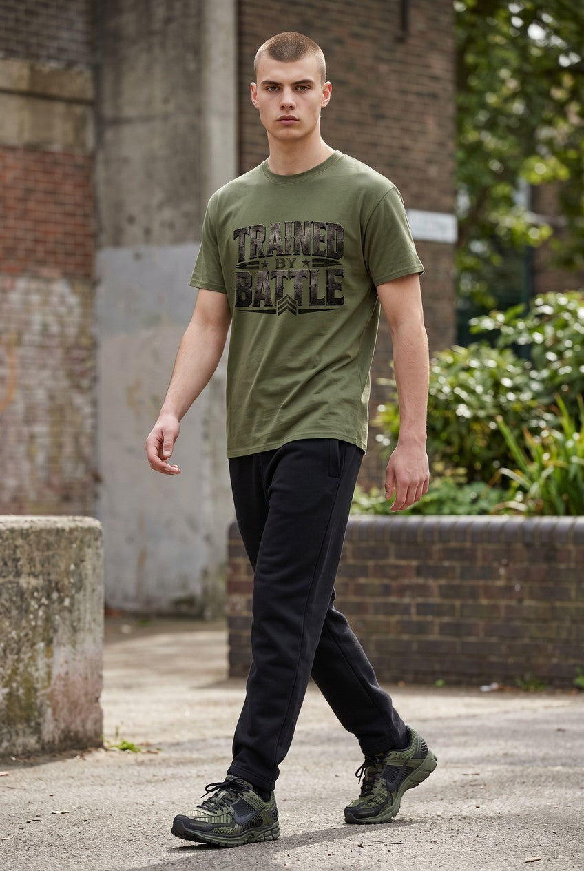 Man wearing a green t-shirt with text, standing outdoors near a brick wall.