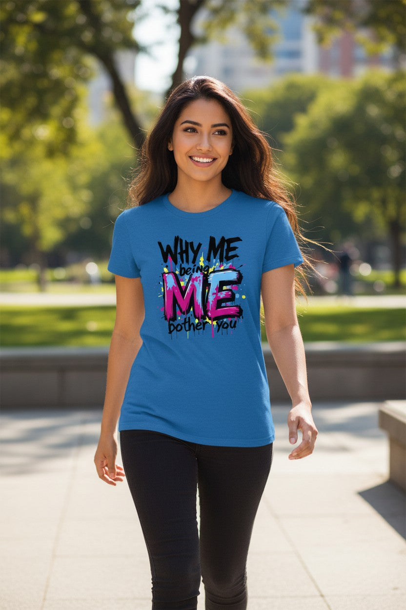 Woman wearing a blue t-shirt with colorful text in an outdoor setting