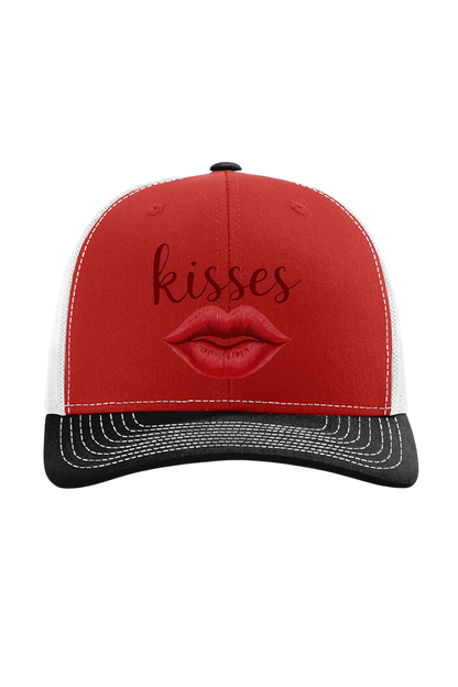 Red and black cap with lips and 'kisses' text on a white background