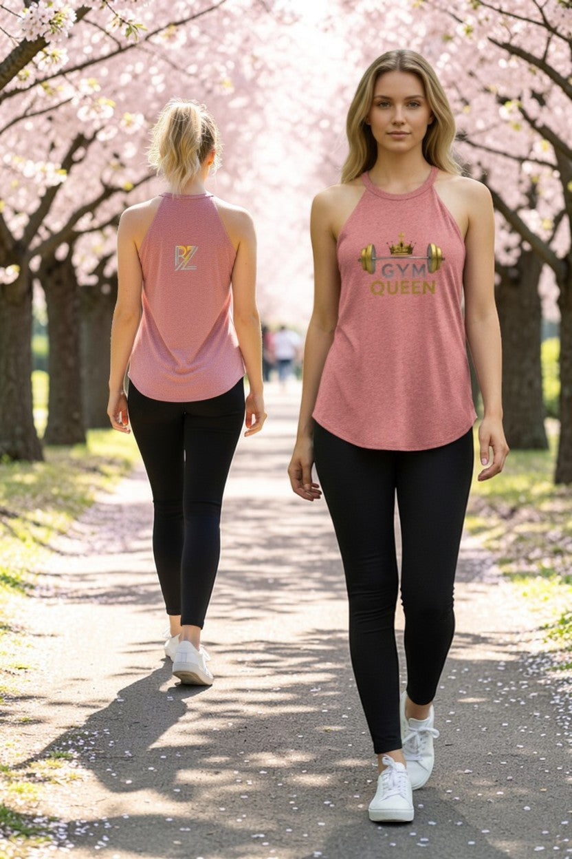 Two women walking outdoors under cherry blossom trees, wearing matching pink tank tops with 'GYM QUEEN' text.