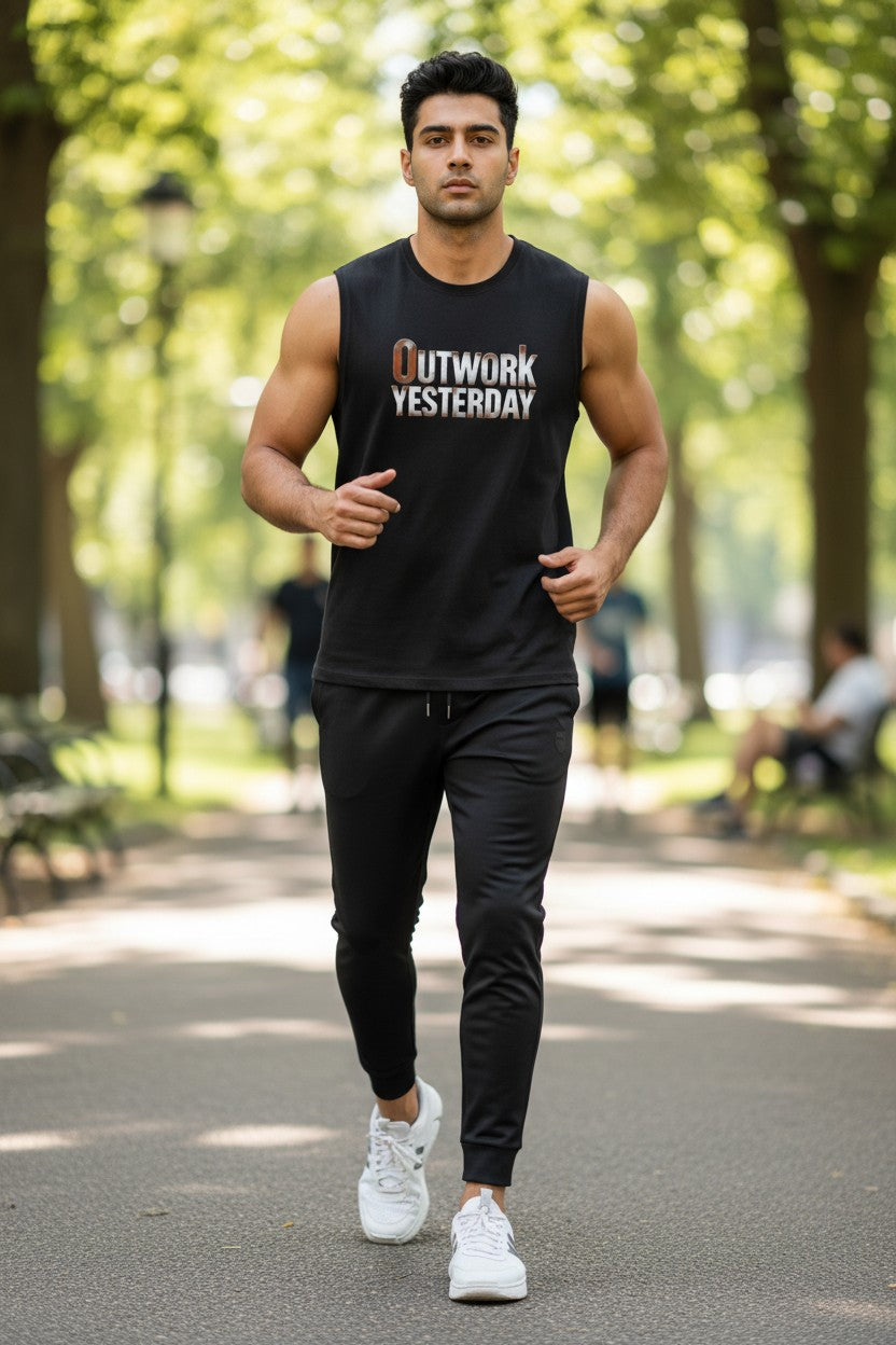 Man in black sleeveless shirt and pants walking in a park