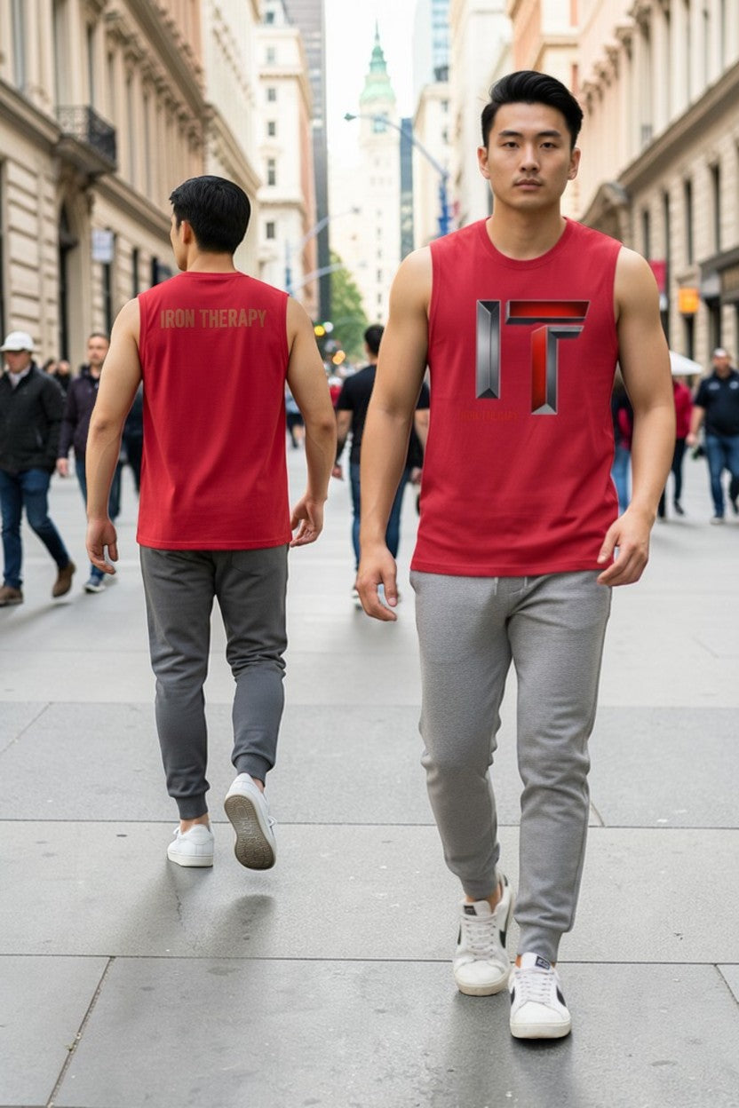 Two men wearing red sleeveless shirts with a logo walking on a city street.