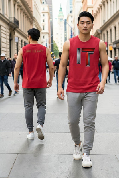 Two men wearing red sleeveless shirts with a logo walking on a city street.