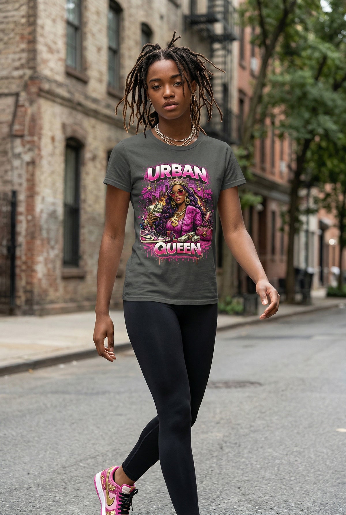 Woman walking on a street wearing a t-shirt with 'Urban Queen' design.