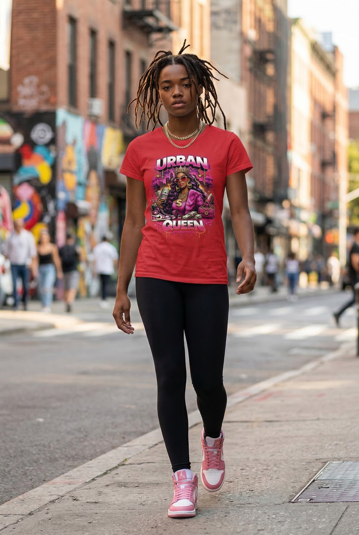 Woman wearing a red t-shirt with graphic design on a city street