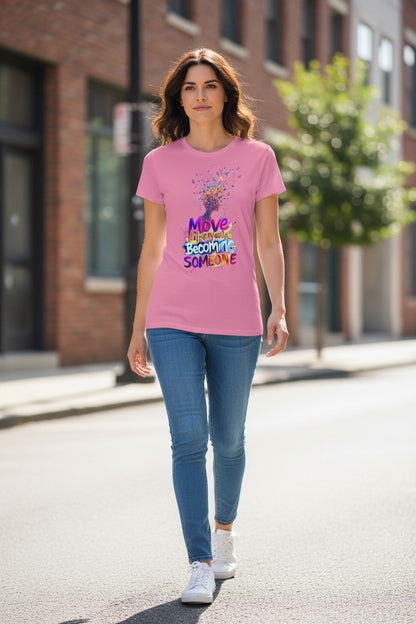 Woman wearing a pink t-shirt with colorful text and graphics, walking on a street.