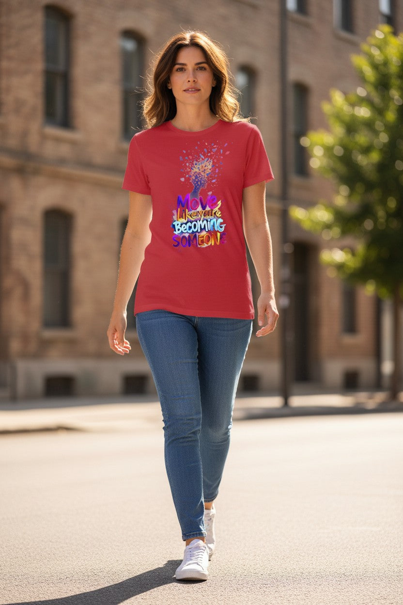 Woman wearing a red t-shirt with colorful text walking on a street.
