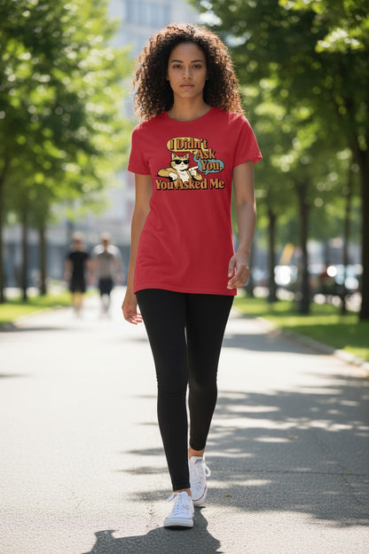 Woman wearing a red t-shirt with text and graphics, walking outdoors on a sunny day.