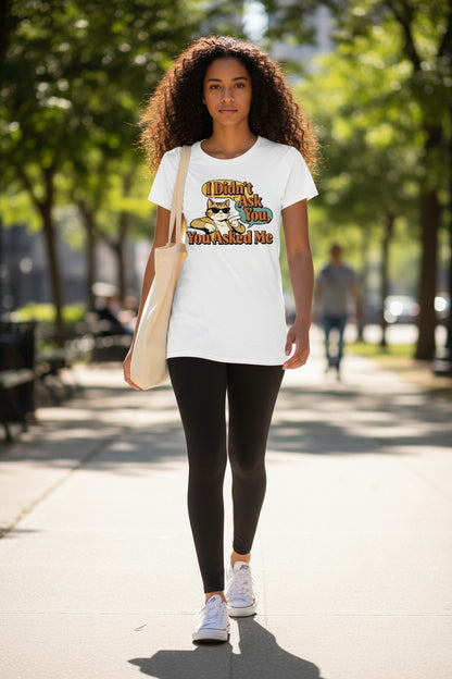 Woman walking outdoors wearing a white t-shirt with text and graphics.