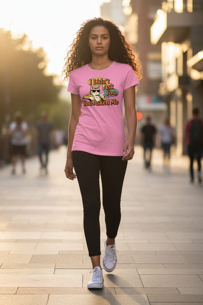 Woman wearing a pink t-shirt with a graphic design on a city street.