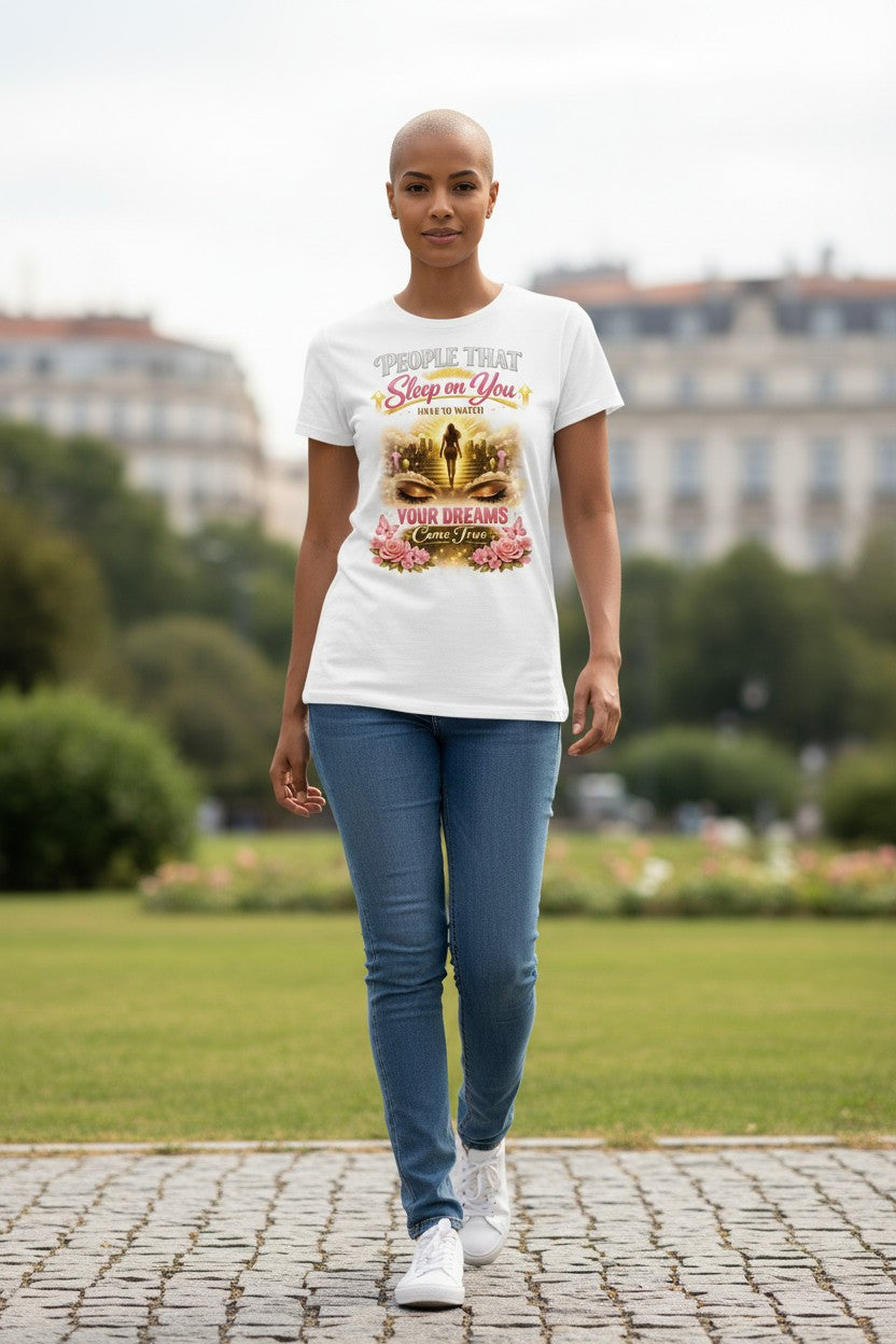 Person wearing a white t-shirt with a colorful graphic design in an outdoor setting.