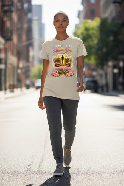 Person walking on a city street wearing a t-shirt with a graphic design.