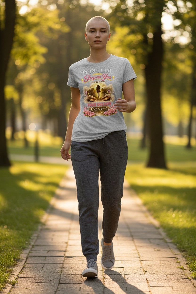Person walking on a path in a park wearing a t-shirt with a graphic design.