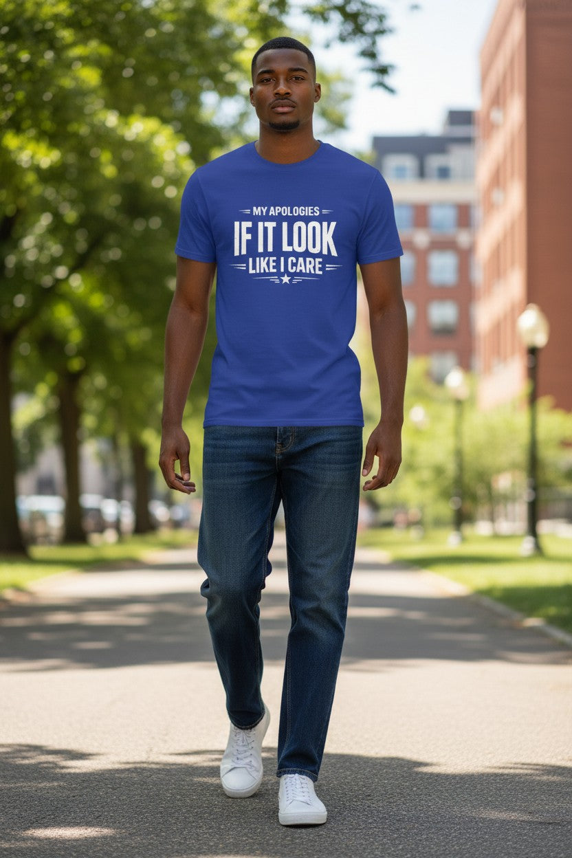 Man wearing a blue t-shirt with text walking on a sidewalk with trees and buildings in the background