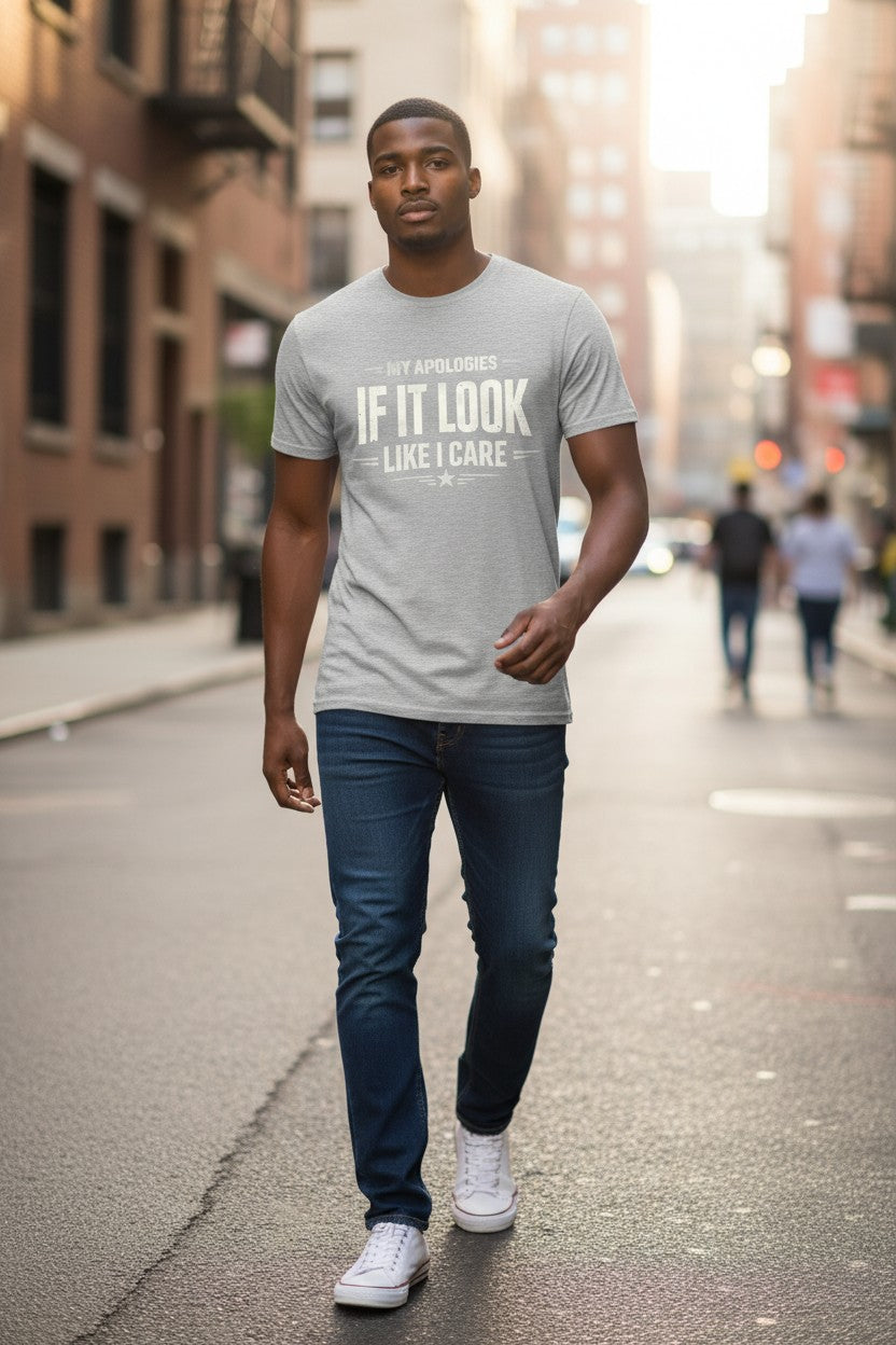 Man walking on a city street wearing a gray t-shirt with text.