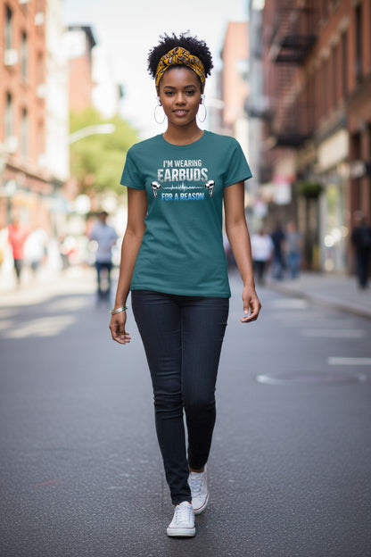 Woman walking on a city street wearing a teal t-shirt with text.