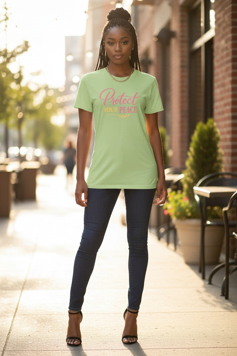 Woman wearing a light green t-shirt with text on a city street.