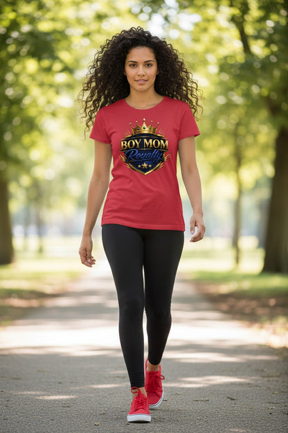Woman wearing a red t-shirt with a logo and text, walking outdoors on a path with trees.