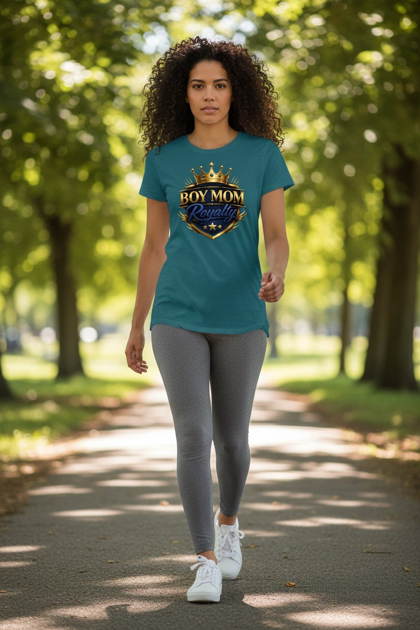 Woman walking outdoors wearing a teal t-shirt with a graphic design.