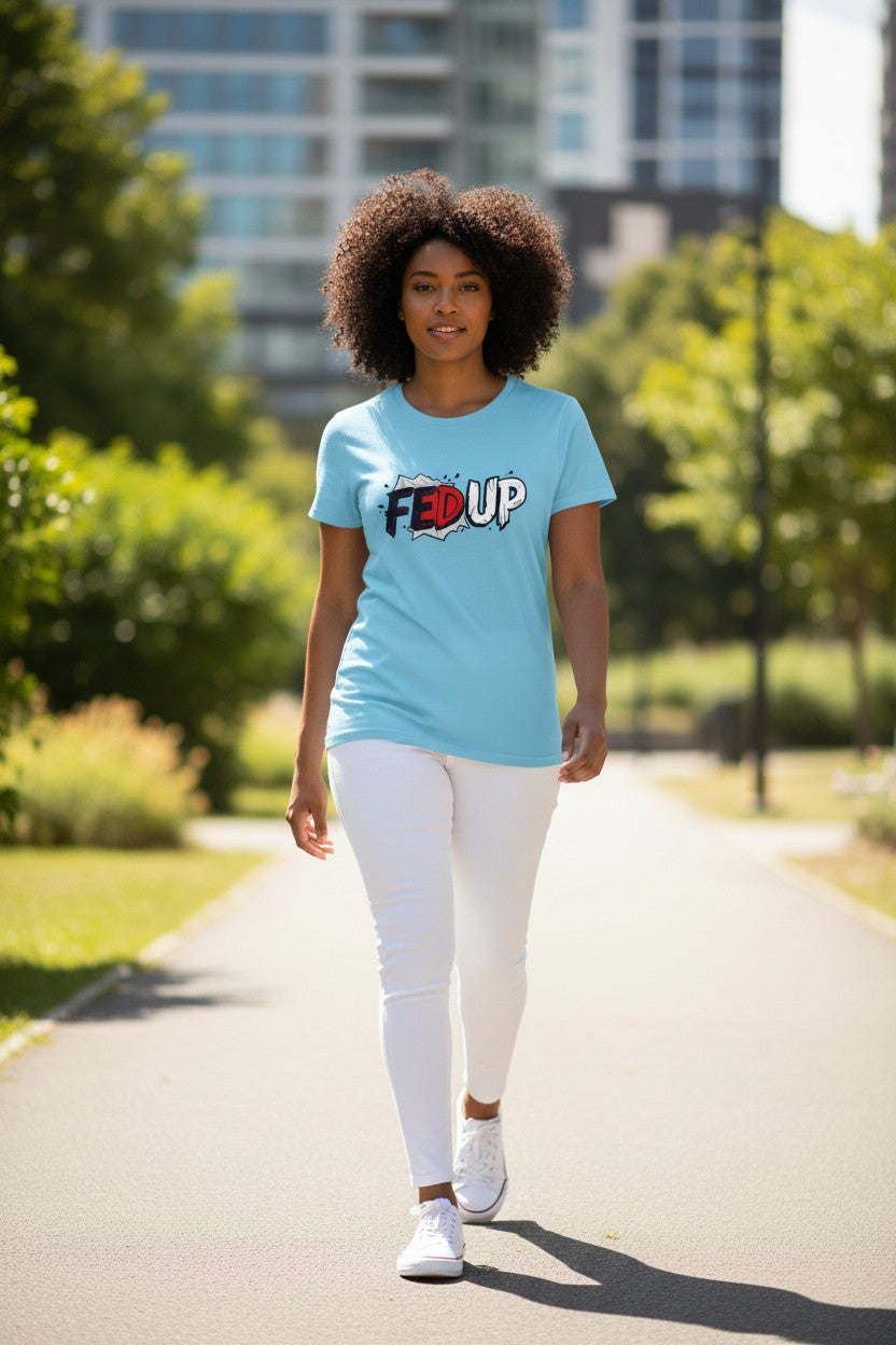 Woman walking outdoors wearing a light blue t-shirt with a logo.