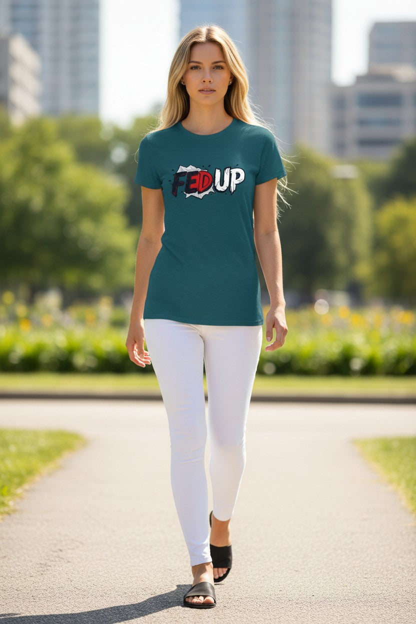 Woman walking outdoors wearing a teal t-shirt with text