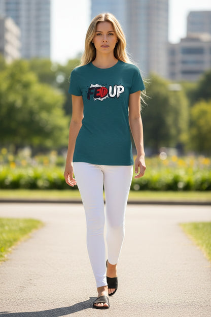 Woman walking outdoors wearing a teal t-shirt with text