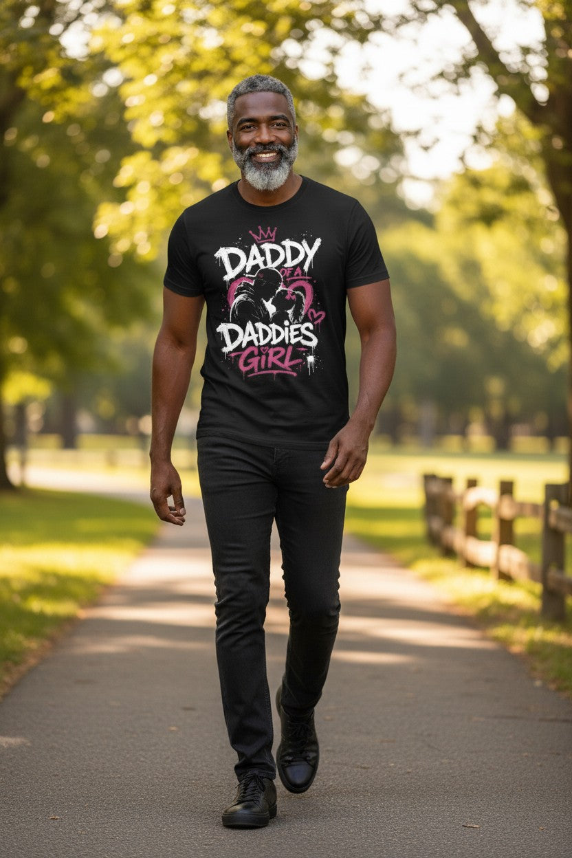 Man walking on a path in a park wearing a black t-shirt with text.