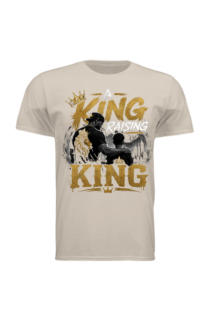 Beige t-shirt with graphic design of a father and son with text 'A King Raising King' on a white background