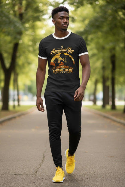 Man walking outdoors wearing a black t-shirt with a graphic design and text, black pants, and yellow shoes.