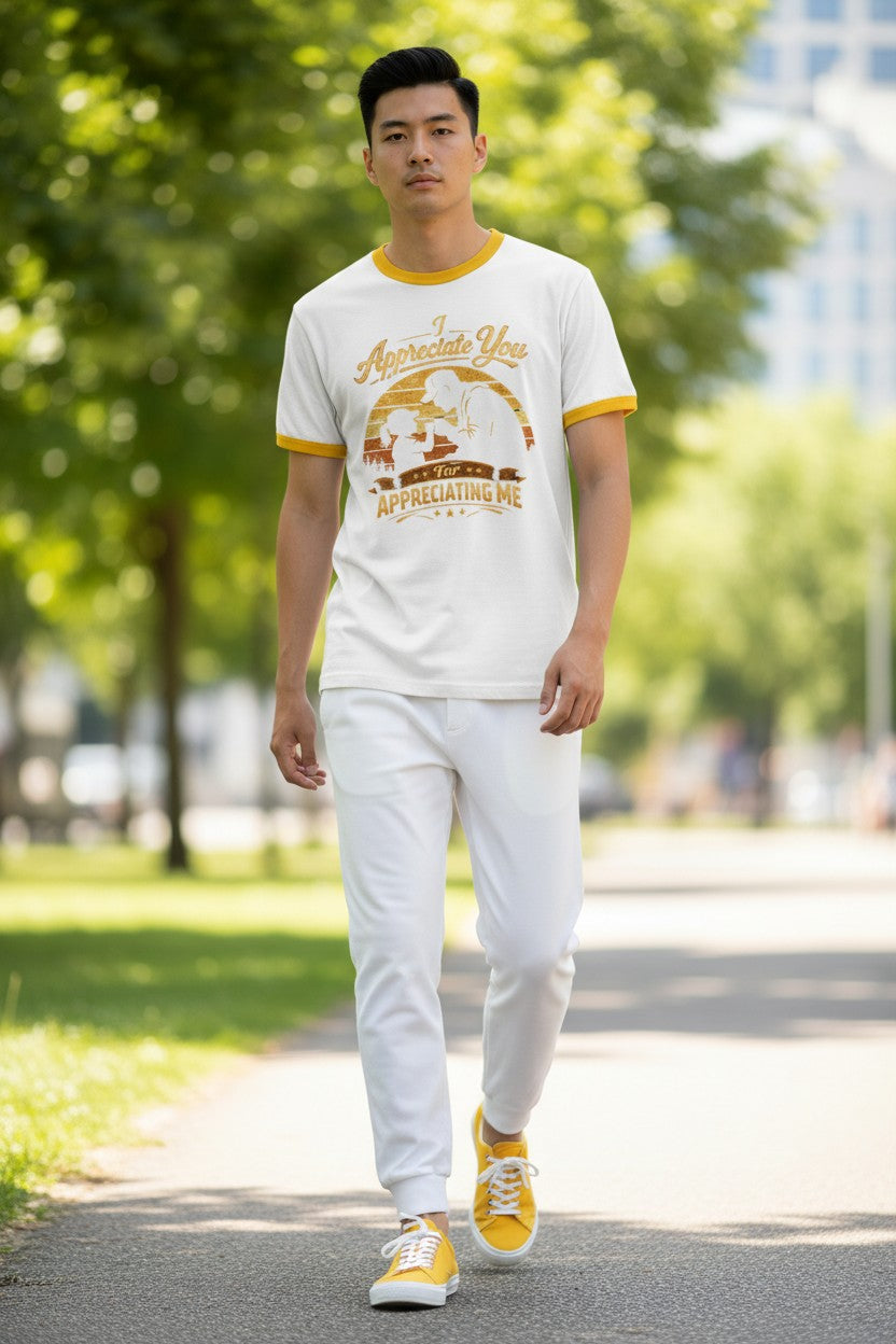 Man wearing a white t-shirt with yellow accents and white pants walking outdoors.