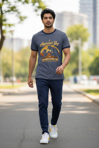 Man walking outdoors wearing a graphic t-shirt and dark pants.