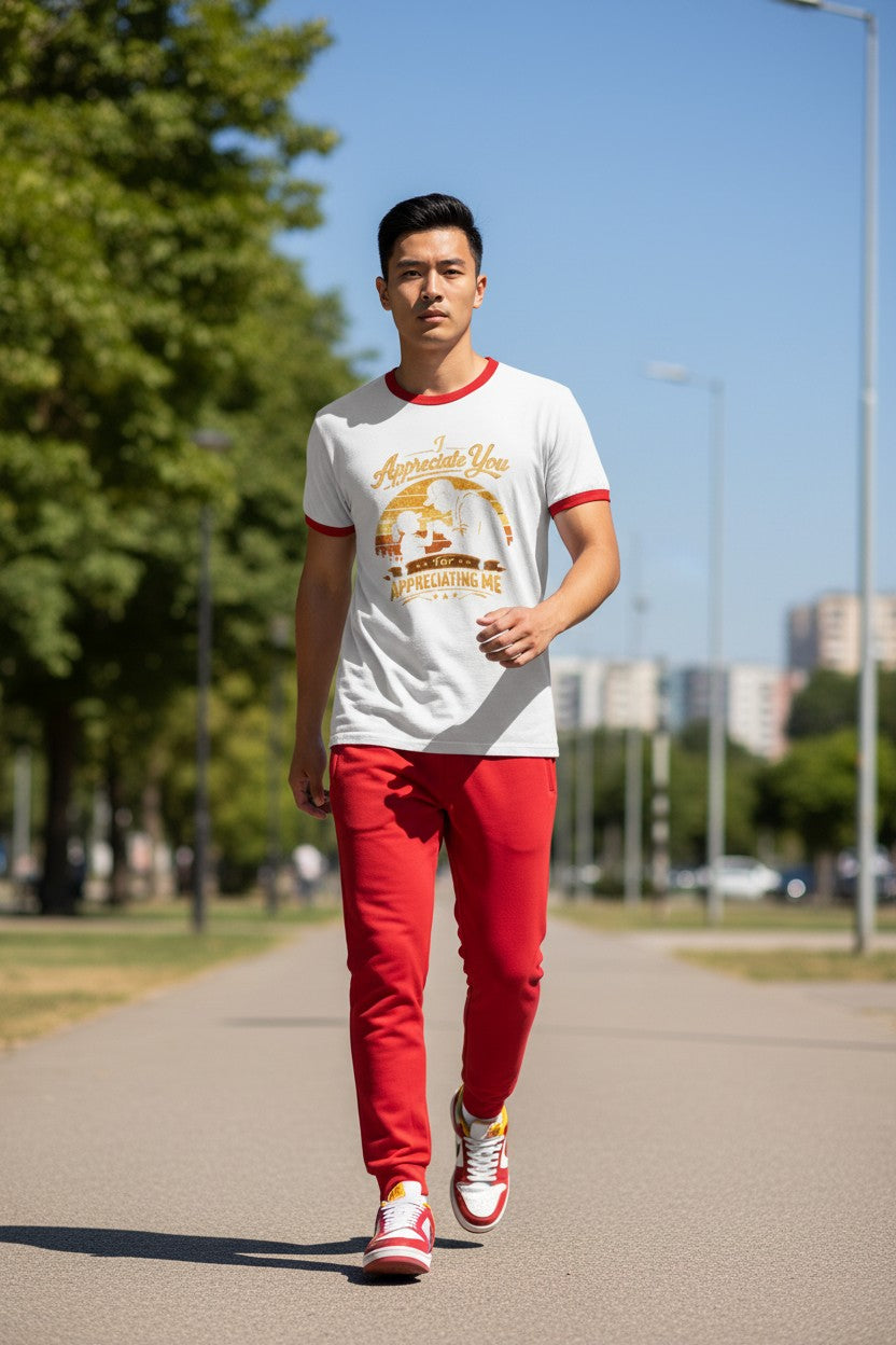 Man walking on a path wearing a white t-shirt with red trim and red pants.